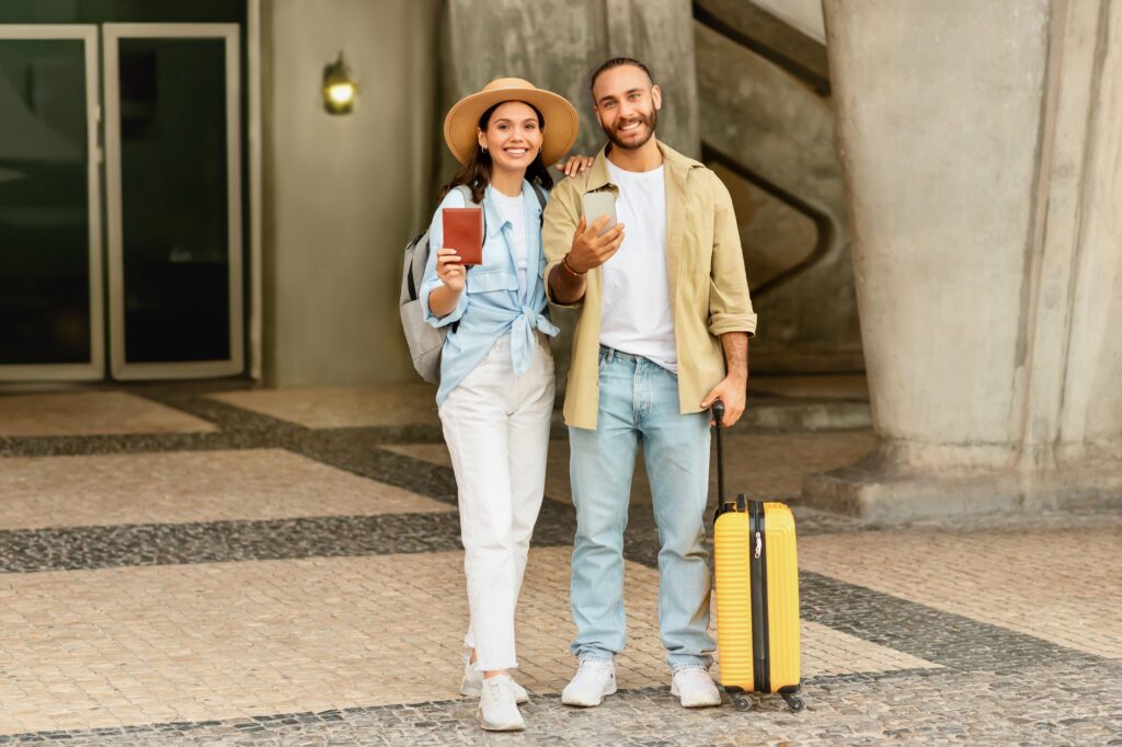 Glad millennial caucasian family with suitcase show passports and tickets, enjoy immigration, trip